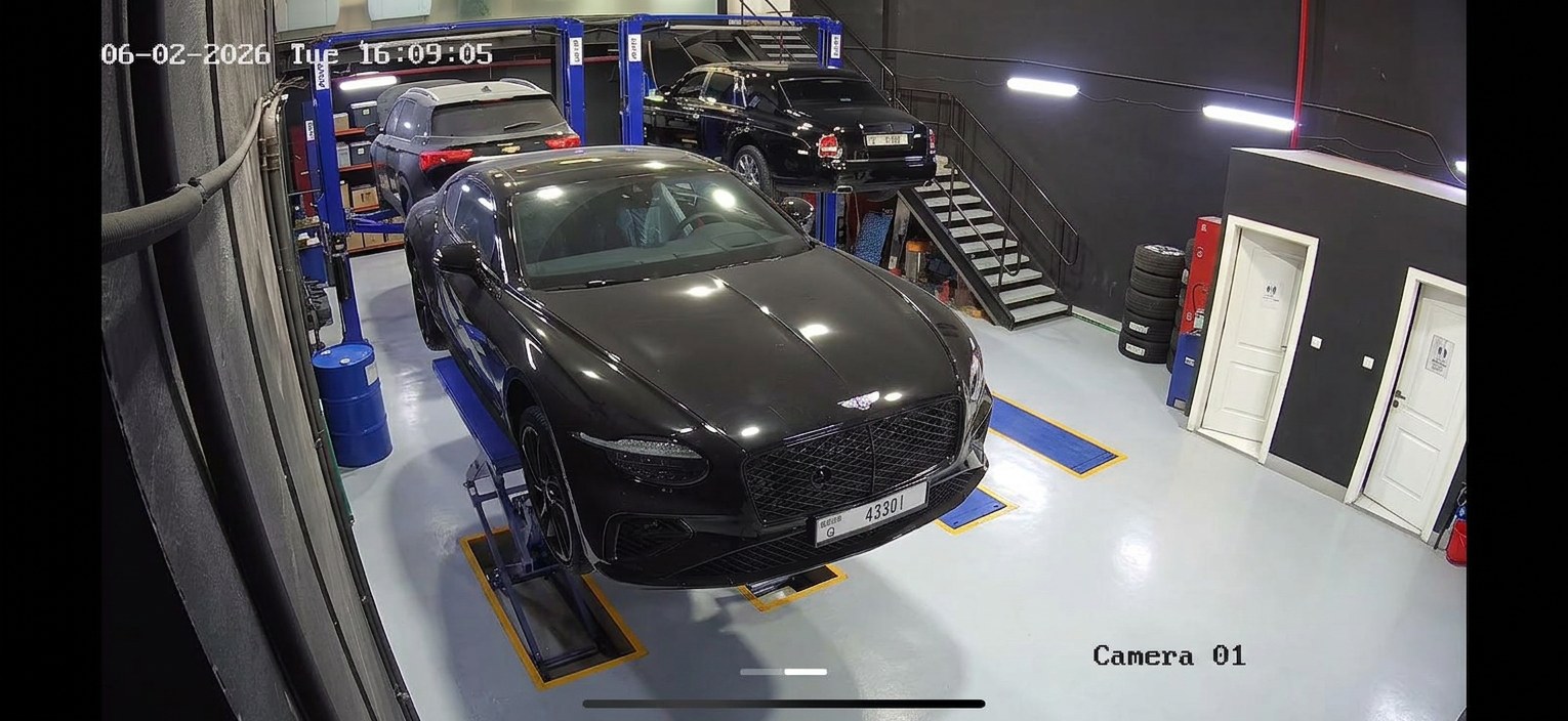 Workshop view of a Bentley Continental GT on the ramp alongside a Rolls-Royce Ghost at BRITFIX