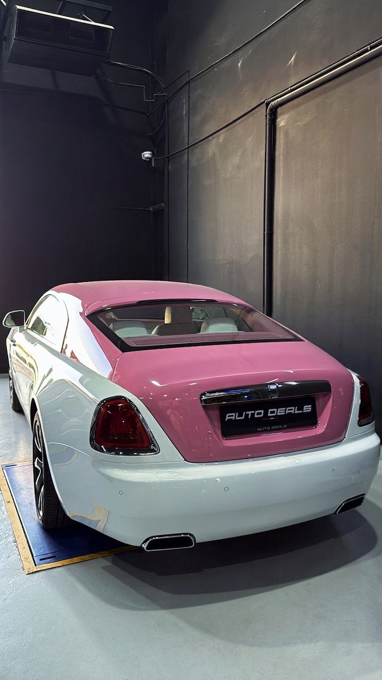Two-tone pink and white Rolls-Royce Wraith on the BRITFIX workshop floor