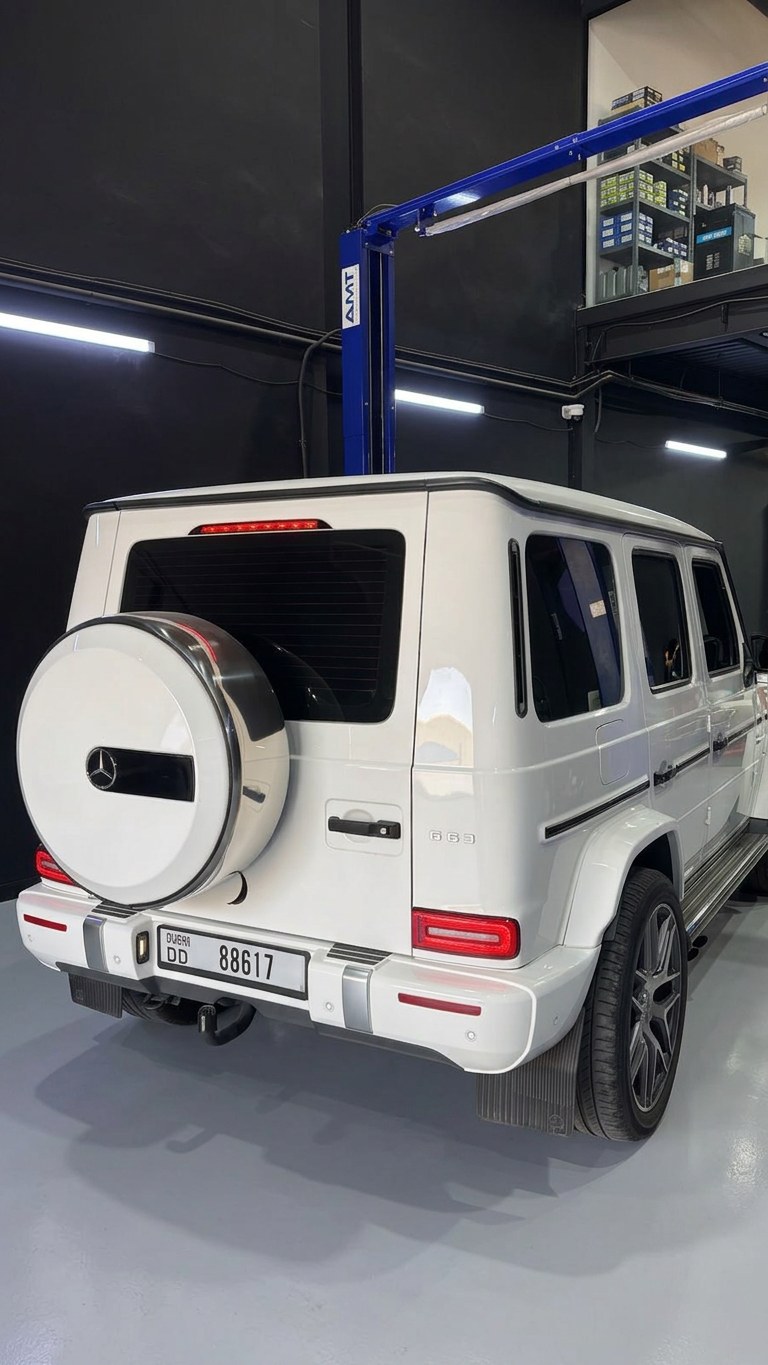 White Mercedes-AMG G63 raised on a two-post lift at the BRITFIX service centre
