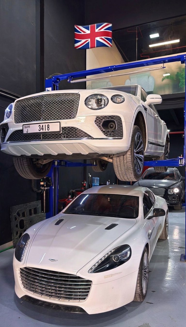 Bentley Bentayga on the lift alongside an Aston Martin Rapide at BRITFIX