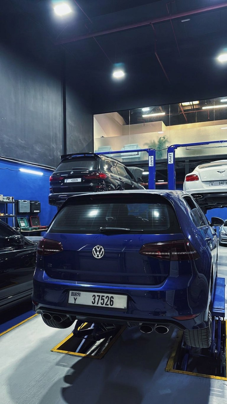 Volkswagen Golf R on the ramp at BRITFIX with a BMW M3 and Bentley on the lifts